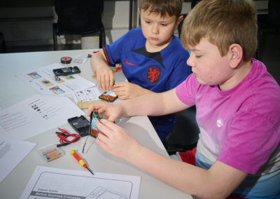 Students learning repair skills with Team Repair kits