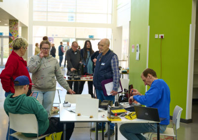 Repairers and 'customers' at repair event at New Line Learning Academy